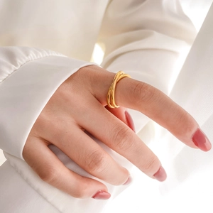 Close-up of interlocking triple band rings in polished gold finish on finger