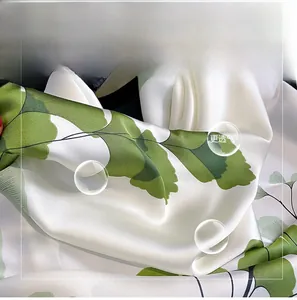 Close-up of silky ginkgo leaf print scarf showing smooth fabric texture and drape