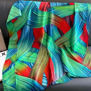 Chic abstract colorful silk scarf with satin finish draped on a neutral fashion background