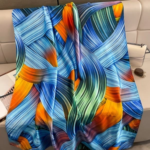 Close-up of elegant artistic silk shawl with colorful abstract patterns and silky luster