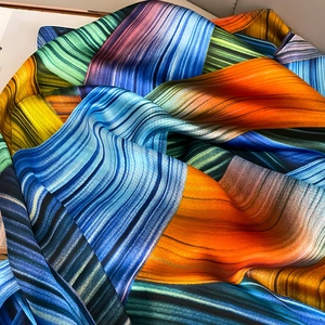 Detailed view of colorful abstract striped silk scarf with elegant drape and satin luster