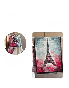 Detailed flat lay of Eiffel Tower pattern scarf with soft fringe and oil painting texture