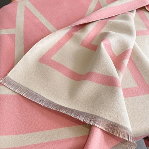 Pink and beige geometric knit scarf with classic letter H pattern and fringe trim
