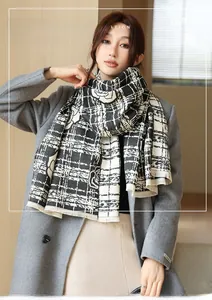 Detail of soft black and white checkered cashmere-like scarf with vintage rose floral patterns