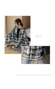 Detail of soft imitation cashmere scarf with black and white floral pattern and tassels