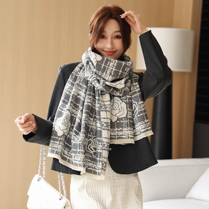 Close-up of camellia pattern cashmere scarf with soft tassels and grey plaid texture