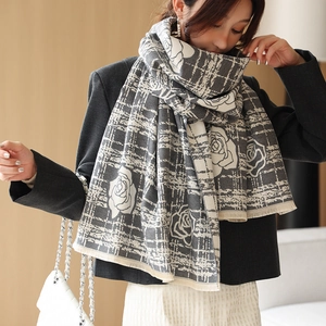 Detail of camellia flower pattern and fringe on a soft cashmere-feel thick winter scarf