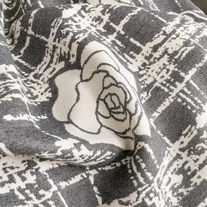 Close-up of thick camellia cashmere scarf fabric with houndstooth and rose pattern