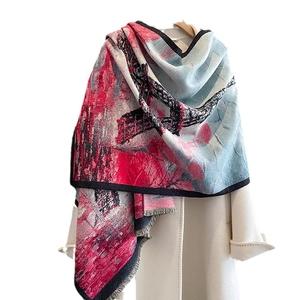 Thick artistic Eiffel Tower print scarf with tassels over a white winter coat