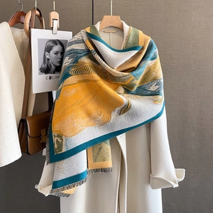 Thick cashmere-like scarf with abstract oil painting print and tassels on a white coat
