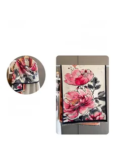 Close-up of pink peony floral print scarf with tassel edges and soft cashmere texture