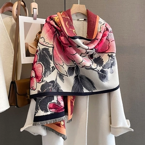 Thick cashmere-feel floral scarf with fringes styled over a white coat for winter