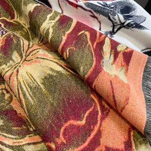Close-up of floral jacquard thick scarf featuring vintage patterns and black fringe edges