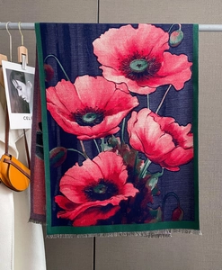 Detail of red poppy floral print on navy cashmere-feel scarf with fine fringe edges