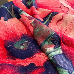 Close-up of thick floral print scarf with shimmering golden metallic glitter threads