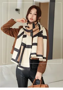 Detailed shot of double-sided cashmere shawl with geometric blocks and fringe trim