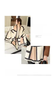 Close-up of geometric color block scarf with soft tassels and imitation cashmere texture