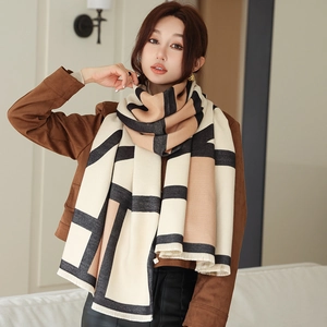 Close-up of geometric color block scarf with soft knit texture and fringe edge detail