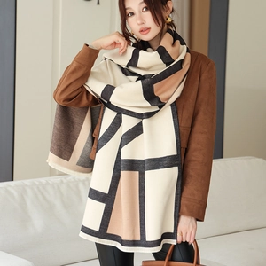 Detail of soft cashmere-like shawl with large color blocks and delicate fringe edges