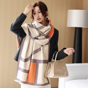 Detail of a large geometric color-block pashmina scarf in cream, orange and purple