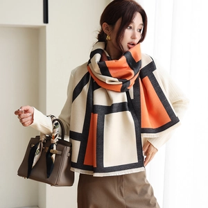 Close-up of color-block geometric pattern scarf with frayed edges and soft texture