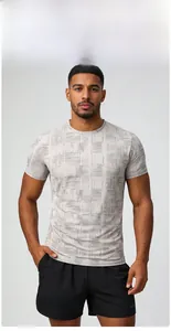 Detail of light gray moisture-wicking sports tee with geometric pattern and crew neck