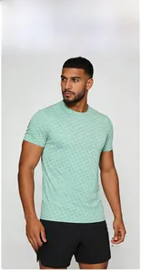 Close-up of light green men's sports t-shirt showing detailed geometric twill texture
