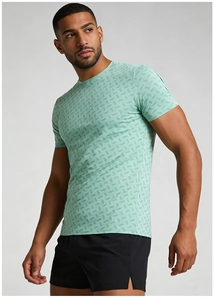 Close-up of quick-dry men's tee showing green geometric pattern and athletic fabric