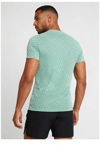 Detail of mint green men's athletic t-shirt showing geometric matrix print and fit
