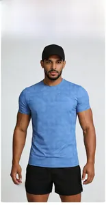 Detail of men's blue quick-dry T-shirt showing geometric pattern and breathable fabric