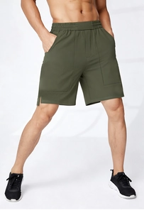 Detail of olive green quick-dry shorts featuring elastic drawstring waist and side slits