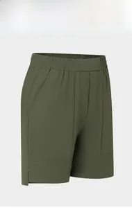 Detail of olive green quick-dry shorts featuring elastic waistband and side slit design