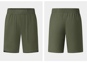 Detail view of olive green quick-dry sports shorts with elastic waist and pockets