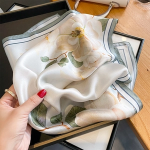 Elegant silk square scarf featuring yellow magnolia floral print with green border