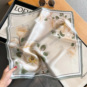 Elegant silk scarf with white camellia floral print on a minimalist aesthetic background