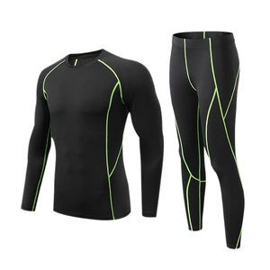 Men's athletic compression set with black long sleeves and pants featuring green stitching