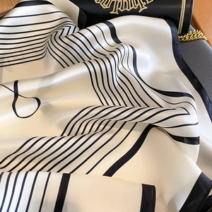 Minimalist striped silk scarf with elegant ivory and black geometric design pattern