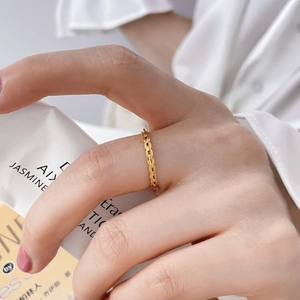 Detailed view of a gold chain link ring featuring a minimalist flat circle design