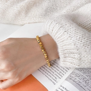 Vintage gold geometric faceted bead chain bracelet for women on a stylish wrist