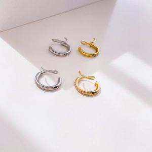Detailed view of twisted spiral C-shaped ear cuffs with micro-paved sparkling zircons
