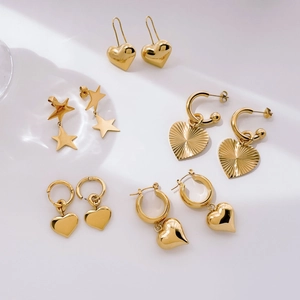 Golden star and heart charm earrings collection with polished finish and cubic zirconia