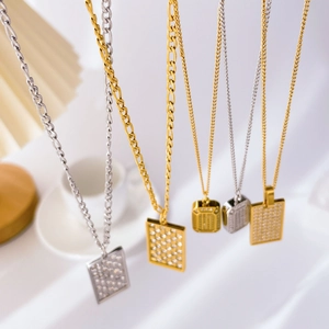 Detailed view of checkered zirconia pendant necklaces in gold and silver finishes