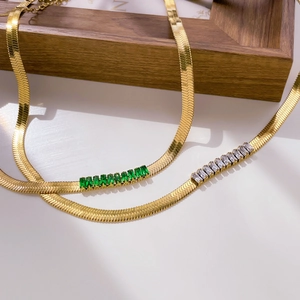 Detail of 18K gold plated herringbone chain featuring emerald and zircon crystal stones