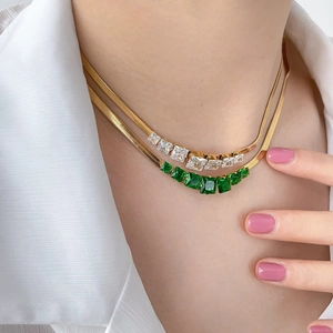 Double-layered 18K gold plated snake chain necklace with cubic zirconia and emerald gems
