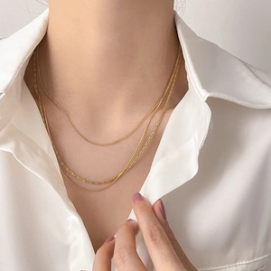 Three-layer layered gold snake chain necklace with mini moon pin and diamond accents