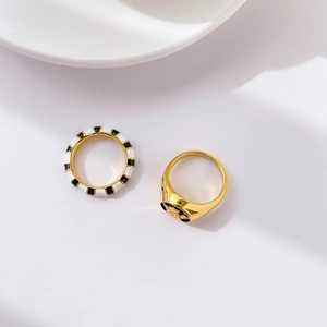 Exaggerated angel carving ring with zebra black and white enamel pattern on gold band