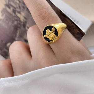 Vintage gold seal ring with black enamel background and 3D angel relief carving