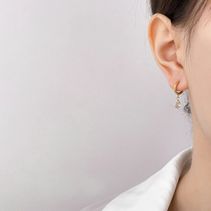 Elegant gold drop earrings with sparkling teardrop-shaped cubic zirconia on model