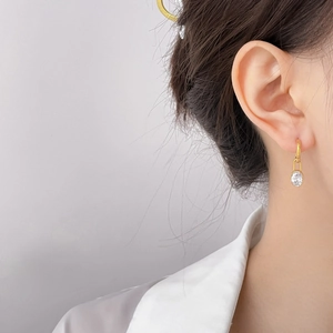 Minimalist gold teardrop earrings featuring sparkling green and white zircon crystals