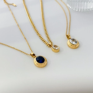 Gold geometric oval pendant necklace set with blue sapphire and white zircon stones